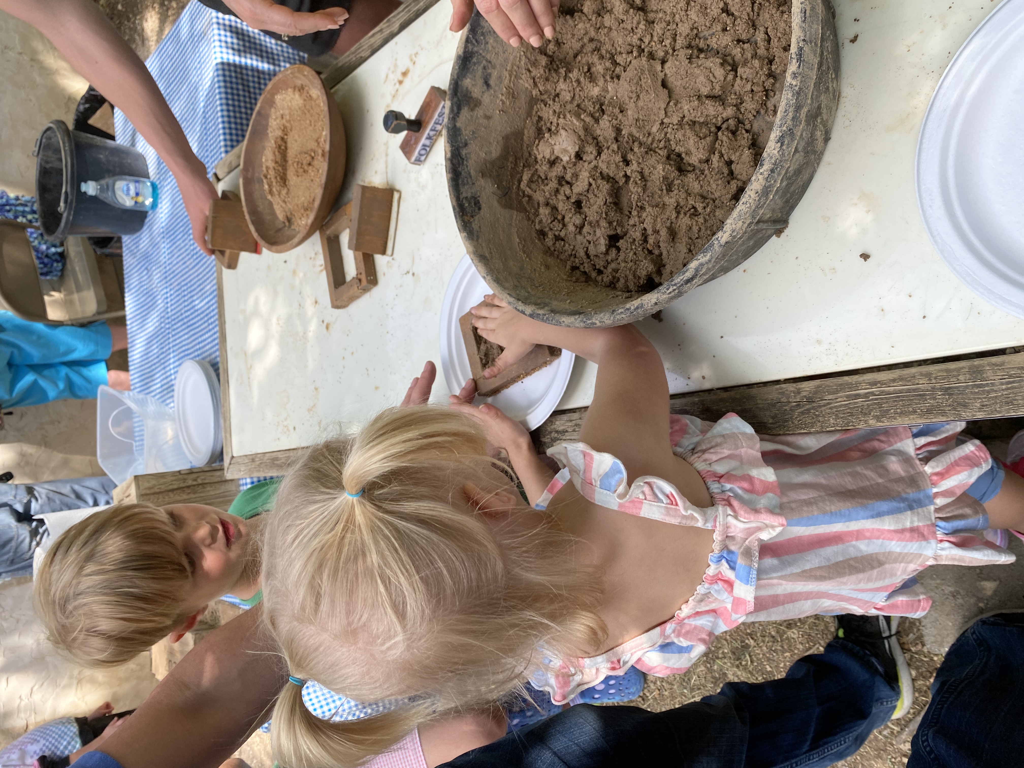 Children learning a traditional hands-on craft together