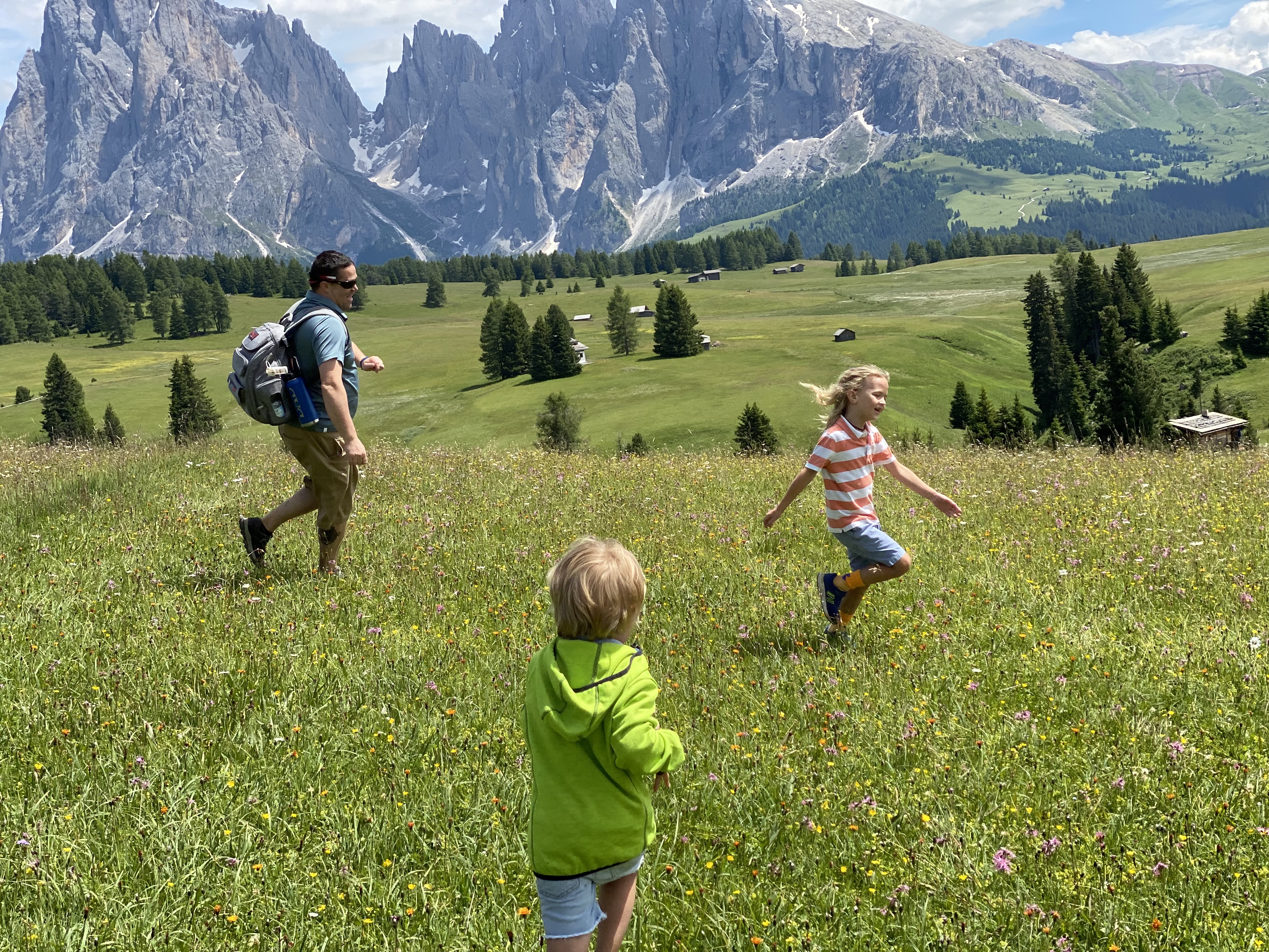 A family exploring a mountain meadow together